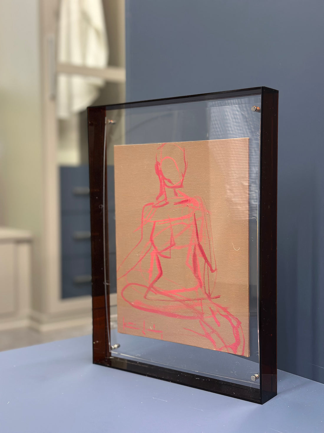 Framed figure in acrylic frame